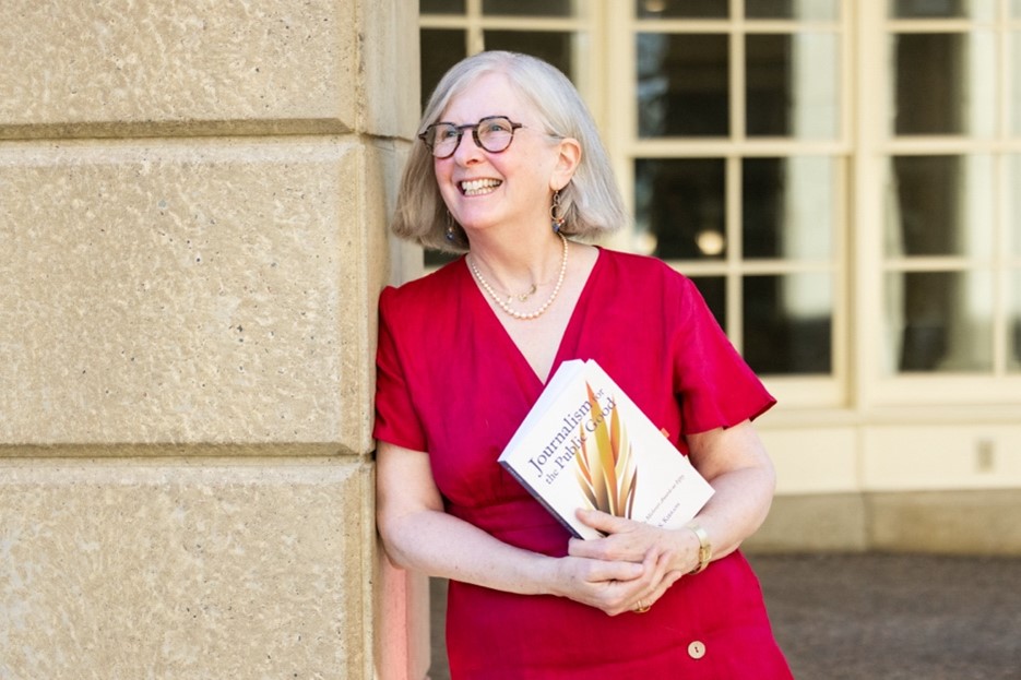 Author Kim Kierans with a copy of Journalism for the Public Good.